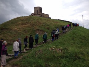 pilgrims walking up a hill to a church in Serbia